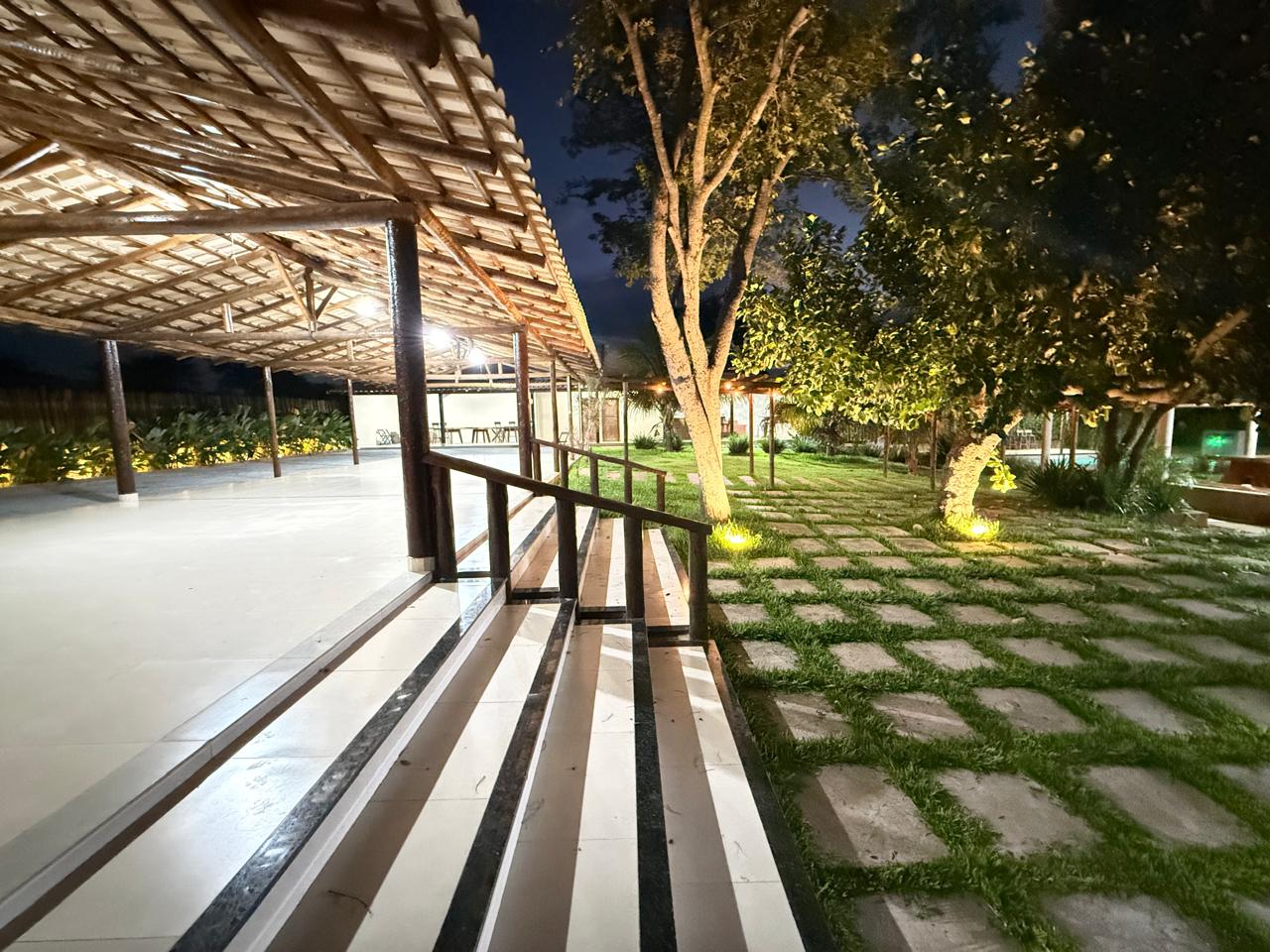 Varanda do salão aberta para o jardim iluminado